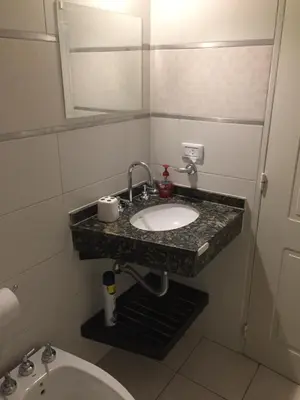 a bathroom with a sink and a toilet at Chacabuco Park in Cordoba