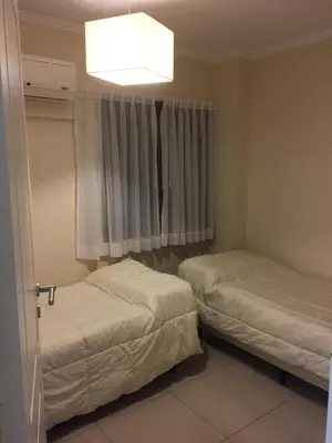 two beds in a small room with a window at Chacabuco Park in Cordoba