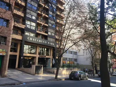 a car parked in front of a building at Chacabuco Park in Cordoba