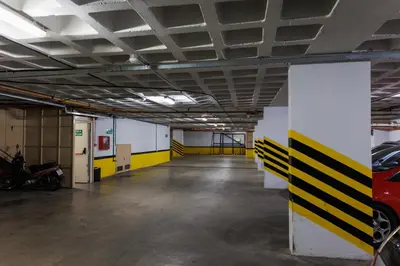 an empty parking garage with cars parked in it at Hotel Petit in Cordoba