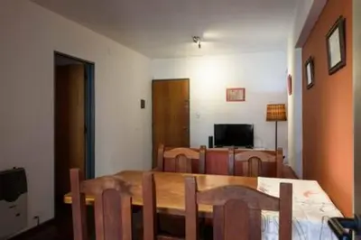 a dining room with a wooden table and chairs at Apartamento Pueyrredón in Cordoba
