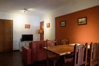 a dining room with a table and chairs and a television at Apartamento Pueyrredón in Cordoba