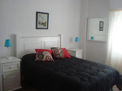 a bedroom with a black bed with two pillows at Departamento sobre principal calle PEATONAL plena zona Finaciera y Comercial in Cordoba