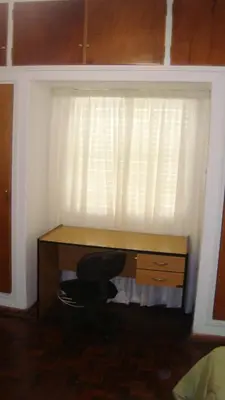 a desk with a chair in front of a window at Departamento sobre principal calle PEATONAL plena zona Finaciera y Comercial in Cordoba