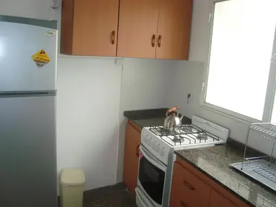 a kitchen with a stove with a cat sitting on it at Departamento sobre principal calle PEATONAL plena zona Finaciera y Comercial in Cordoba