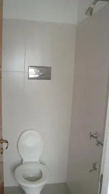 a bathroom with a white toilet in a stall at Departamento sobre principal calle PEATONAL plena zona Finaciera y Comercial in Cordoba