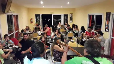a group of people sitting at tables in a room at Apart Hotel Vista San Lucas in Carpintería