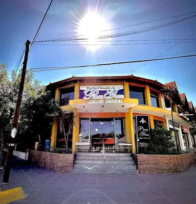 a building with a restaurant on a street at Apart Hotel Piscu Yaco in Merlo
