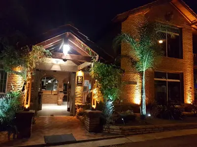 a brick house with lights on it at night at Apart Hotel Piscu Yaco in Merlo