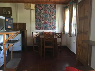a kitchen with a table and chairs in a room at Sol de Bach in Tanti
