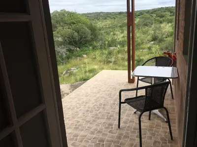 a table and chairs on a porch with a view at Sol de Bach in Tanti