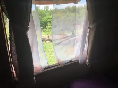 a window with pink curtains in a room at Sol de Bach in Tanti