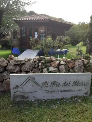 a sign in front of a small house at al pie del morro in Merlo