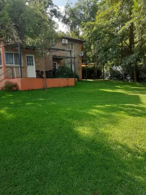 a yard with a house with a green lawn at al pie del morro in Merlo