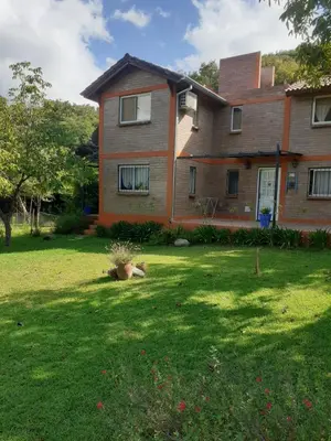 a large house with a dog laying in the yard at al pie del morro in Merlo