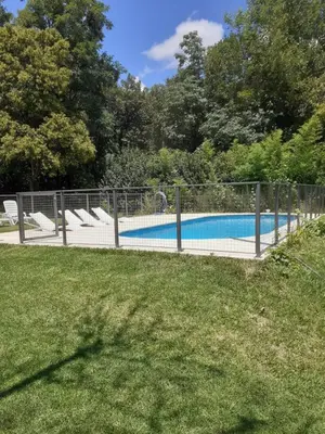 a fence around a swimming pool in a yard at al pie del morro in Merlo