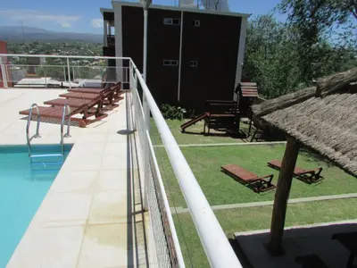 a balcony of a house with a swimming pool at La Villa Inn in Villa Carlos Paz