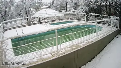 a swimming pool with snow on top of it at La Villa Inn in Villa Carlos Paz