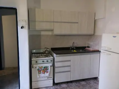 a kitchen with a stove and a white refrigerator at Casa en Santa Rosa de Calamuchita in Santa Rosa de Calamuchita