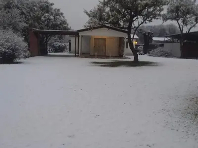a yard covered in snow in front of a house at Casa en Santa Rosa de Calamuchita in Santa Rosa de Calamuchita