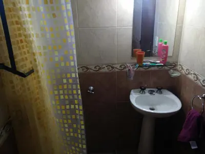 a bathroom with a sink and a shower with a mirror at Casa en Santa Rosa de Calamuchita in Santa Rosa de Calamuchita