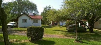 a house with a car parked in the yard at Entre Sierras in Villa General Belgrano