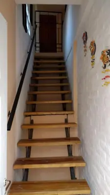 a staircase with wooden steps in a building at Complejo ARABELA in Merlo