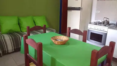 a kitchen with a green table with a basket on it at Complejo ARABELA in Merlo