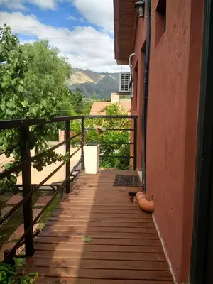a wooden walkway leading up to a house with a view at Complejo ARABELA in Merlo