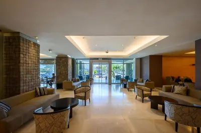 a lobby with couches and chairs and tables at Orfeo Suites Cordoba in Cordoba