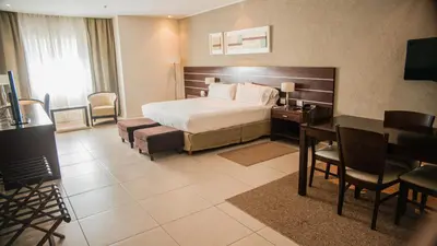a hotel room with a bed and a desk at Orfeo Suites Cordoba in Cordoba
