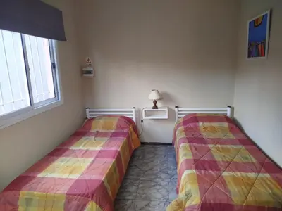 two beds sitting next to each other in a room at Departamento Manna in Alta Gracia