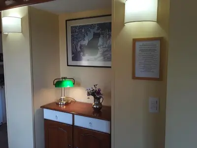 a hallway with a table with a lamp on it at Cabanas Vista Hermosa in Santa Rosa de Calamuchita