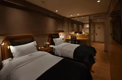 a hotel room with two beds and a kitchen at Windsor Hotel in Cordoba