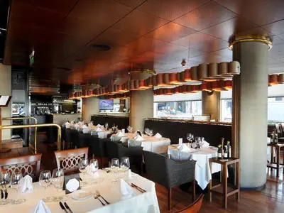 a dining room with white tables and chairs at Windsor Hotel in Cordoba