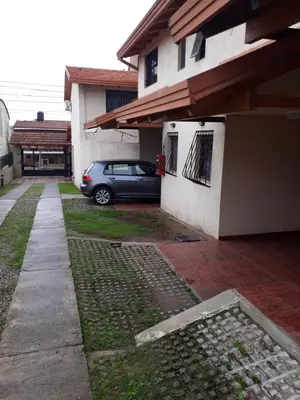 a car parked in front of a house at Complejo Camila in Villa Carlos Paz