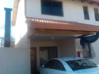 a car parked in front of a house at Complejo Camila in Villa Carlos Paz
