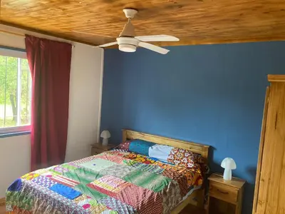 a bedroom with a bed with a ceiling fan at La Casa de Don Pepe in Villa de Las Rosas