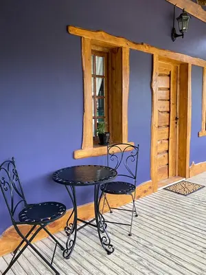 a table and two chairs in a room with a window at Suenos del Bosque ApartHotel in Atos Pampa