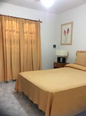 a bedroom with a bed and a window at Robinson Apartamentos SOLO FAMILIAS in Villa Carlos Paz