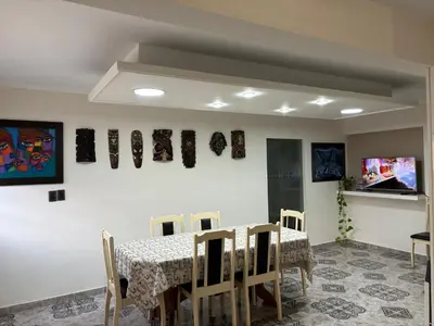 a dining room with a table and chairs at Robinson Apartamentos SOLO FAMILIAS in Villa Carlos Paz