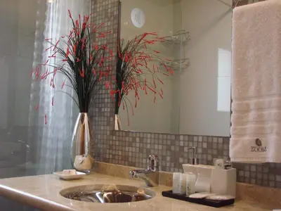 a bathroom with a sink and a mirror at Zoom Apartments Hotel in Cordoba