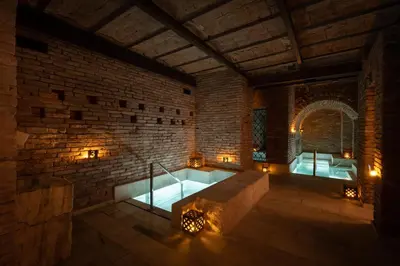 a room with a bath tub in a brick wall at Azur Hotel & Spa in Cordoba