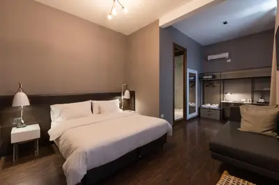 a bedroom with a large bed and a couch at Azur Hotel & Spa in Cordoba