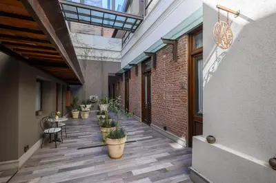 a hallway with potted plants and tables in a building at Azur Hotel & Spa in Cordoba