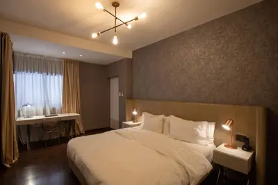 a bedroom with a large white bed and a window at Azur Hotel & Spa in Cordoba