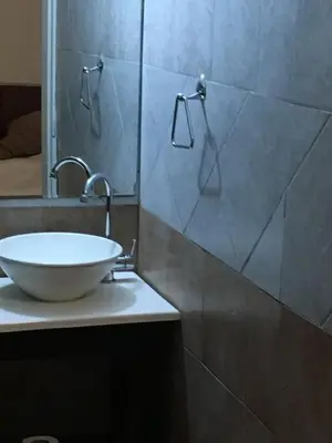 a bathroom with a sink and a mirror at Del Fundador in Cordoba