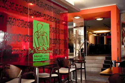 a restaurant with a red wall with writing on it at Del Fundador in Cordoba