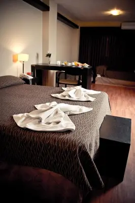 a hotel room with a bed with white towels on it at Del Fundador in Cordoba
