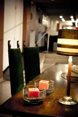 a table with two candles and a lamp on it at Del Fundador in Cordoba